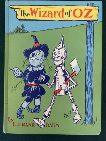 Here is an unusual version of "The Wizard of Oz", 1st of the Oz books written by L Frank Baum. Copyright 1956 by Reilly & Lee, this is a short-lived Denslow poster cover version. According to Bibliographia Oziana, this "blue cover" printing was only printed in 1964, and was replaced by the more common white cover version in 1965, which accounts for it being less common. The blue cover illustration is integral to the front and rear cover, and is adapted from a 1900 W. W. Denslow poster advertising the Wizard of Oz. The eye-popping endpapers depict a red and purple Denslow poppy illustration. There are also single color (blue, red, and green depending on section) Denslow illustrations throughout the text, based on the true 1st edition of The Wonderful Wizard of Oz. Here is an unusual version of "The Wizard of Oz", 1st of the Oz books written by L Frank Baum. Copyright 1956 by Reilly & Lee, this is a short-lived Denslow poster cover version. According to Bibliographia Oziana, this "blue cover" printing was only printed in 1964, and was replaced by the more common white cover version in 1965, which accounts for it being less common. The blue cover illustration is integral to the front and rear cover, and is adapted from a 1900 W. W. Denslow poster advertising the Wizard of Oz. The eye-popping endpapers depict a red and purple Denslow poppy illustration. There are also single color (blue, red, and green depending on section) Denslow illustrations throughout the text, based on the true 1st edition of The Wonderful Wizard of Oz. This book is in near fine condition, clean and tight with only light wear, tight hinges, no writing or tears. A very attractive book overall.